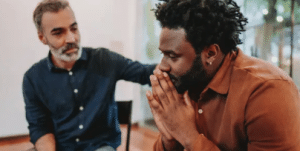 Two men comforting each other